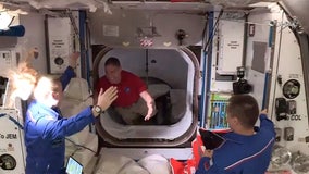 SpaceX capsule with 4 astronauts docks with space station