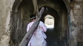 Iraqi Christians reenact Jesus carrying the cross on Good Friday