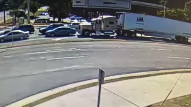 Truck driver charged after pushing car into an intersection