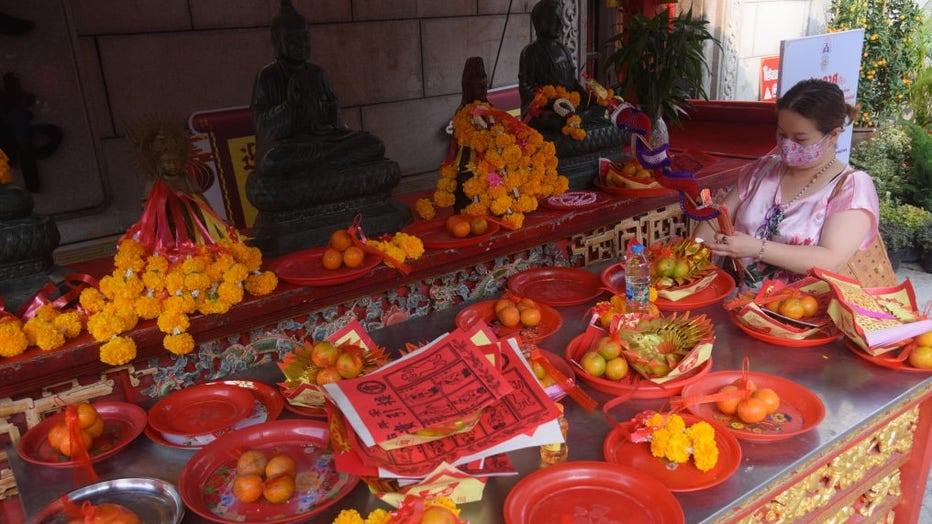 A woman offering prays ahead of the Chinese New Year in