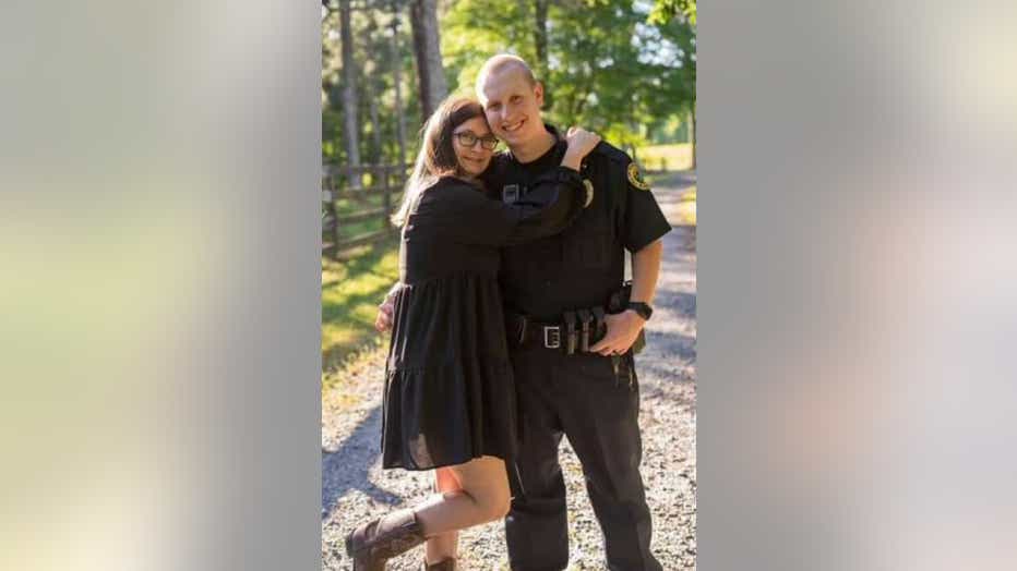 Officer Joe Burson (right) pictured with his wife. The Holly Springs Police Department officer was killed in the line of duty.