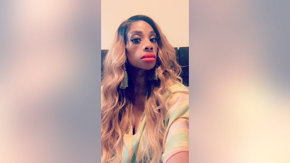 African American woman with long hair poses for selfie