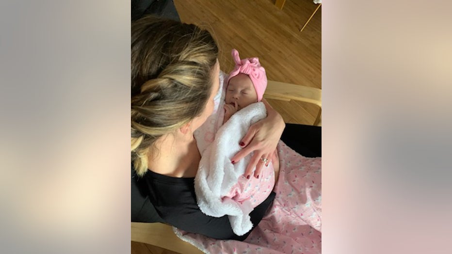 Mother holds newborn baby