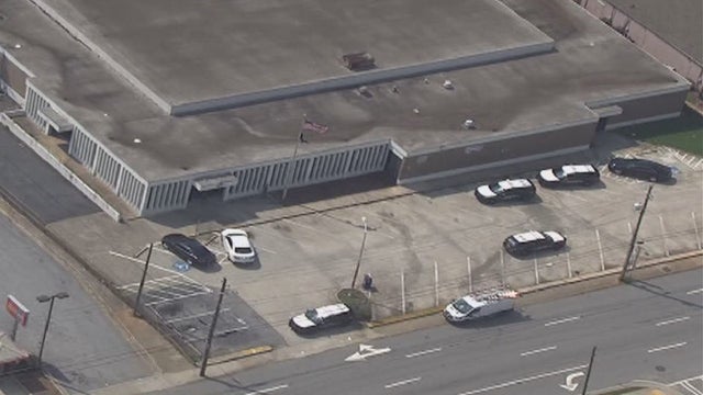 Officers, suspect smash through window during struggle at East Point post office, police say