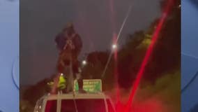 Joyriding man chained to top of Escalade in latest viral Detroit freeway video