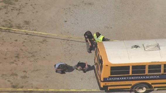 Police: School bus rolls onto driver making repairs in Fairburn, killing her
