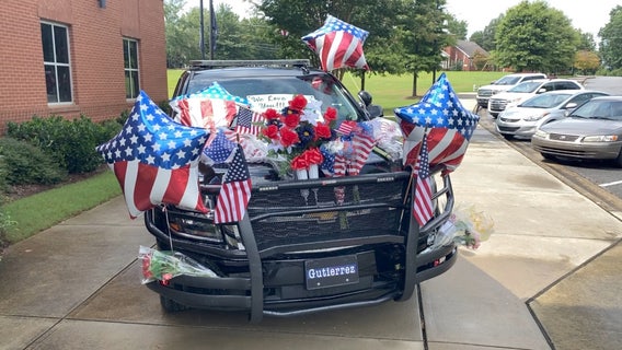 Newnan officer’s patrol car now a memorial outside his department