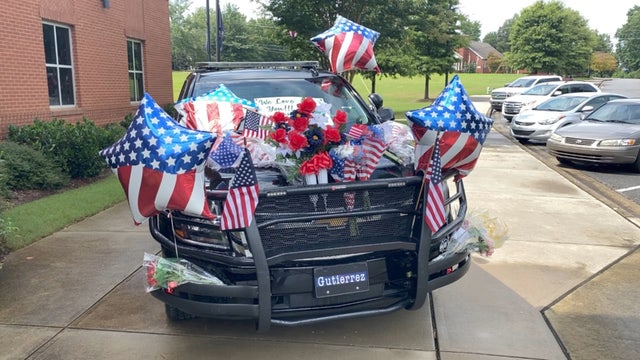 Newnan officer’s patrol car now a memorial outside his department