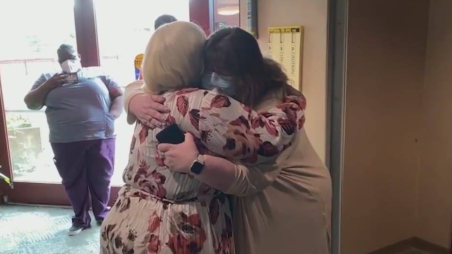 Andrionna Williams hugs a member of the ICU staff at Piedmont Fayette Hospital who she credits with saving her life last summer during the third wave of the COVID-19 pandemic.