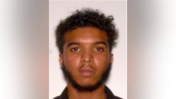 Man wanted after being caught on camera punching a woman and kicking her car