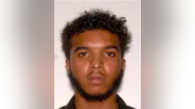 Man wanted after being caught on camera punching a woman and kicking her car