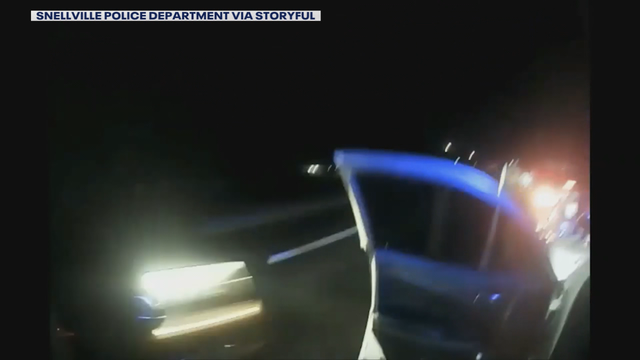 Officer's bodycam shows near-miss with passing car during traffic stop