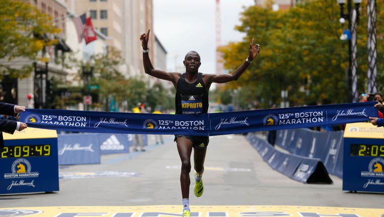 Boston - October 11: Men's racer Benson Kipruto crosses the Finish Line to win the 125th Boston Marathon in Boston on Oct. 11, 2021. (Photo by Jessica Rinaldi/The Boston Globe via Getty Images)