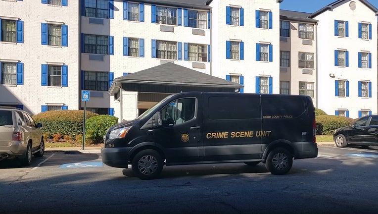 A crime scene van was parked in front of the Police were called to the InTown Suites Extended Stay along Barrett Creek Parkway NW after receiving a report of a body found on Oct. 18, 2021.