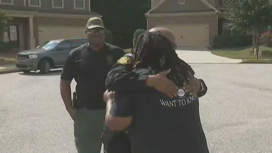 D'Anna Muhammad hugs a member of the South Fulton Metro SWAT team who helped her son during a mental health crisis.