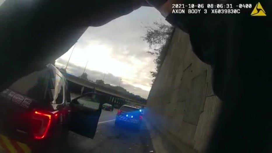 Officer Steven Randerson documents the scene of a crash on the shoulder of I-75 north of 17th Street NW just moments before being hit by a car on Oct. 6, 2021.