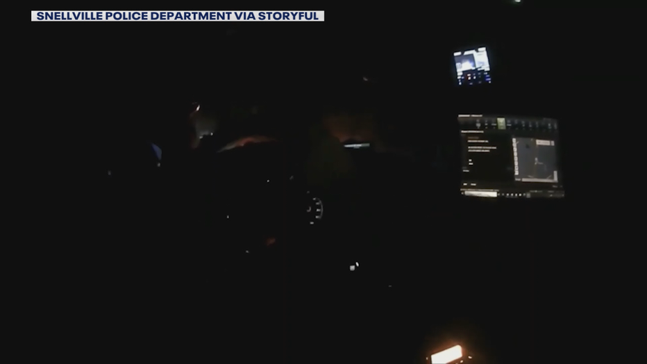 In this still from bodycam released by the Snellville Police Department, an officer can be seen in his patrol car moments before a traffic stop along Georgia 124 on Sept. 29, 2021.