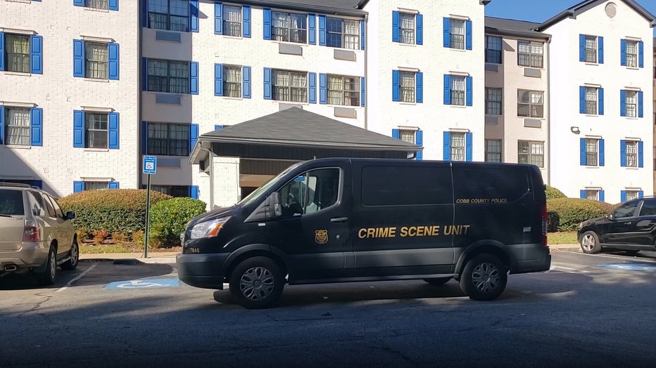 A crime scene van was parked in front of the Police were called to the InTown Suites Extended Stay along Barrett Creek Parkway NW after receiving a report of a body found on Oct. 18, 2021.