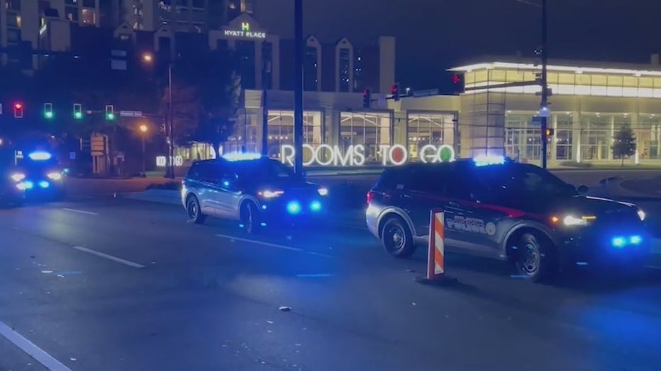 Police investigate the scene where a woman died after being ejected from a Lamborghini near the intersection of Peachtree and Piedmont roads in Buckhead on Oct. 12, 2021.