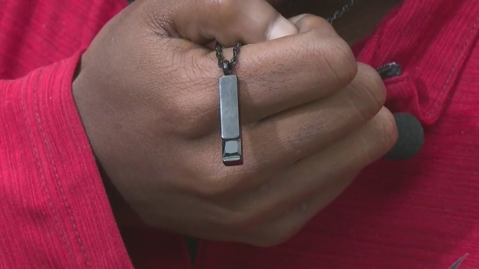 Ezekial Brown clutches a neckless that contains ashes of his older brother Jarmichael.