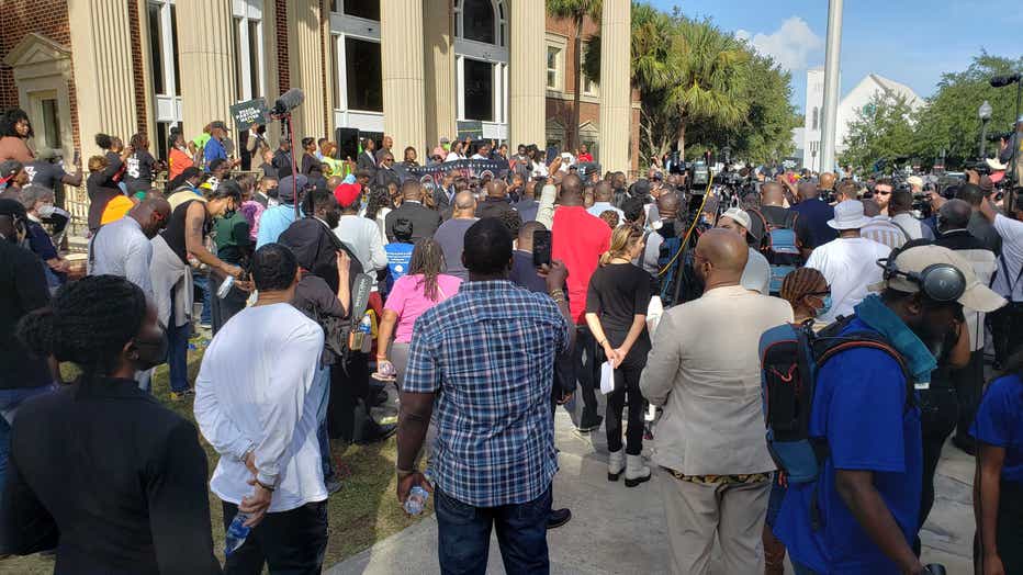 Hundreds gather outside the Glynn County courthouse in response to a defense lawyer’s bid to keep Black ministers out of the courtroom on Nov. 18, 2021.