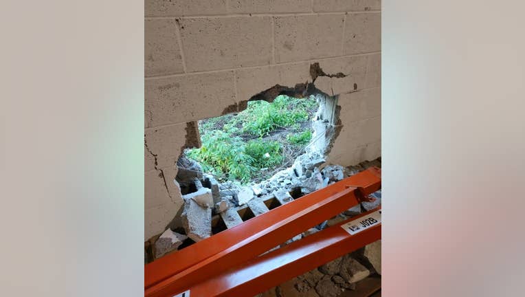 The Empty Stocking Fund shared this photo on their Facebook page showing the hole smashed into their warehouse wall after a break-in on Dec. 22, 2021.