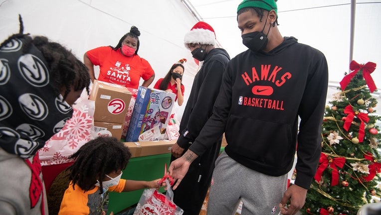 The Atlanta Hawks help distributed gifts to underserved children in Atlanta on Dec. 18. 2021.