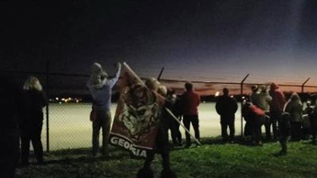 Fans cheer for the Dawgs as they head off to Indy