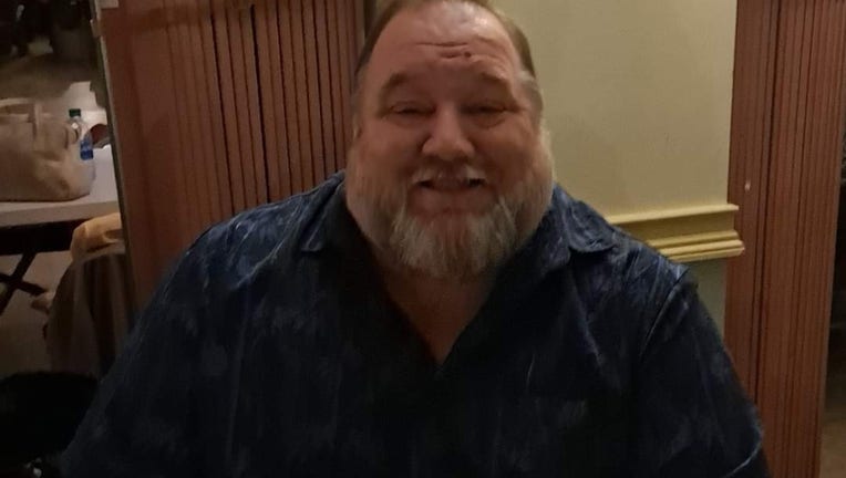 Bearded man smiles while sitting at a table inside an American Legion post.