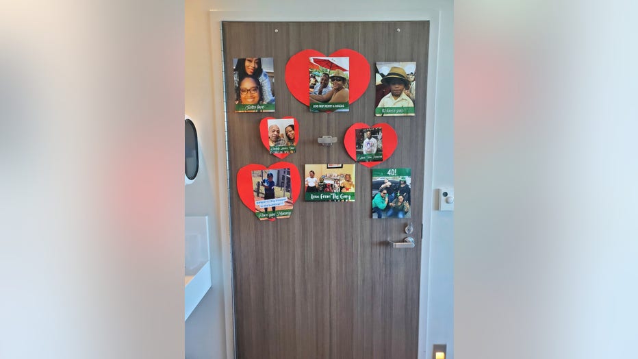 A hospital room door is decorated with photos of the patient's family and friends.