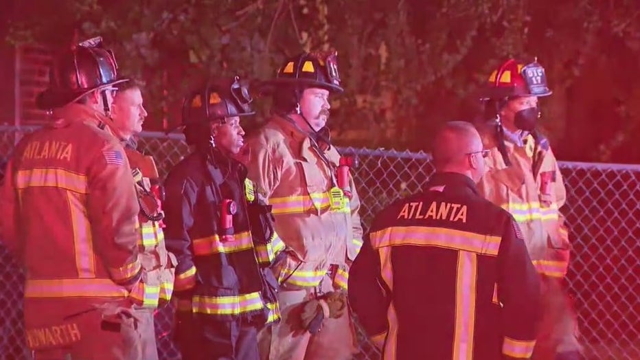 Firefighters investigate a house fire in southwest Atlanta on Jan. 3, 2022.