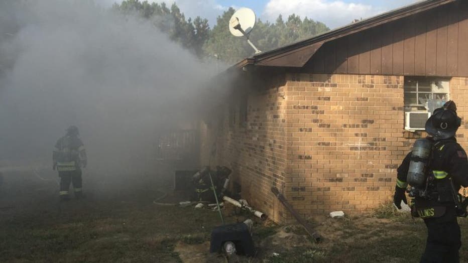Firefighters battle a house fire in Walton County on Nov. 16, 2021.
