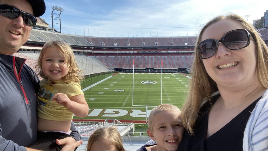 Family poses for selfie at Sanford Stadium at UGA