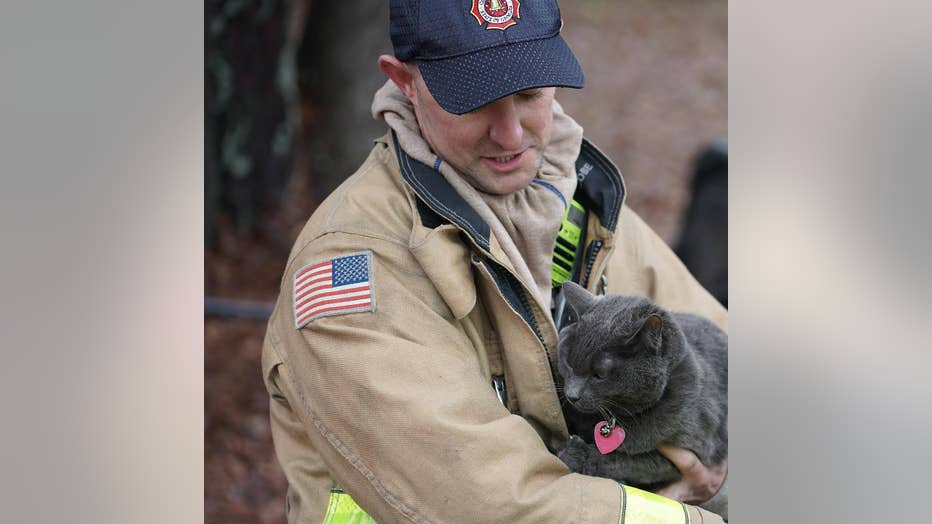 Firefighters work to battle a blaze and resuscitative a cat found inside a Cobb County home on Feb. 4, 2022.