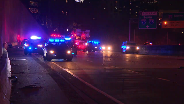 Driver, passenger injured after car rolls off roadway on to Interstate 75