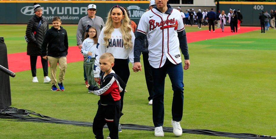 Atlanta Braves' Freddie Freeman, his wife Chelsea and son Charlie arrive  during a celebration at Truist Park, Friday, Nov. 5, 2021, in Atlanta. The  Braves beat the Houston Astros 7-0 in Game