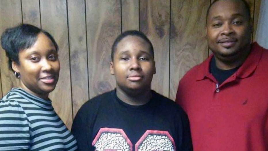 Johnny Tolbert posses with his mother and father.