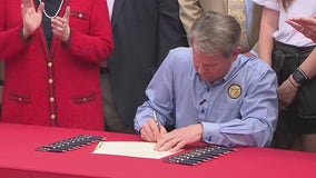 Kemp signs bill allowing people to carry handguns without a license in Georgia into law