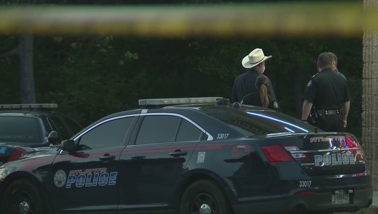 Police investigate a deadly shooting of a security guard outside a southwest Atlanta restaurant on April 18, 2022.