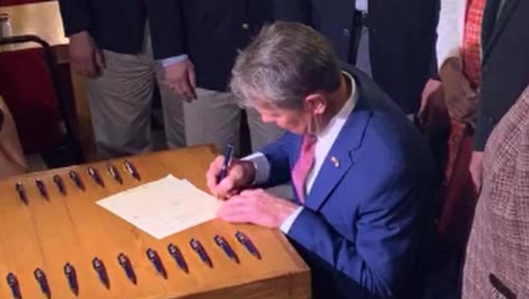 Gov. Brian Kemp signs a tax cut into law on April 26, 2022.