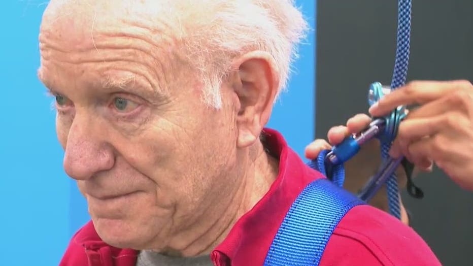 Bob Spector is tethered while working out to prevent him from falling.