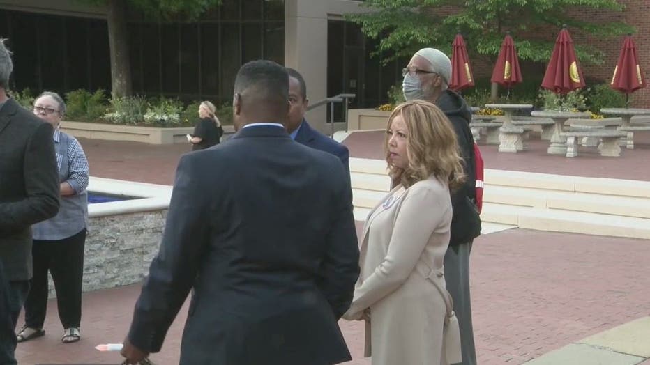 Rep. Lucy McBath joins the 100 Black Men of Atlanta for a candlelight vigil for shooting victims at the King Center on April 20, 2022.