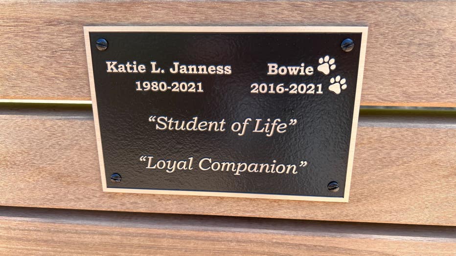A plague on a bench inside Piedmont Park dedicated to Katie Janness and her dog Bowie reads