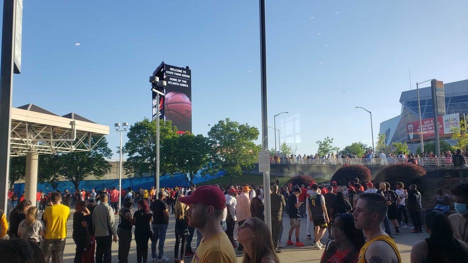 Fans wait outside State Farm Arena in Downtown Atlanta due to a report of a suspicious package that delayed Game 3 between the Hawks and the Heat on April 22, 2022.