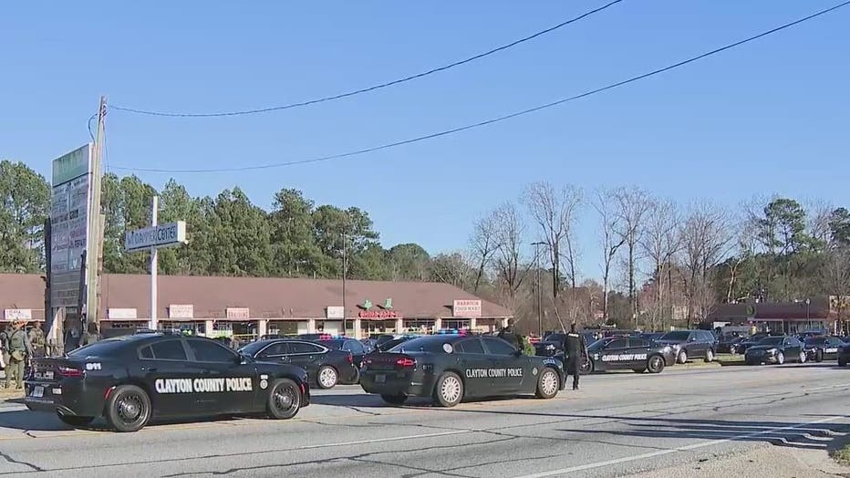 Police investigate after a Clayton County police officer and another man were shot on March 2, 2022.