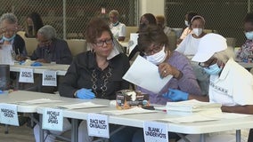 DeKalb election workers hand count ballots in District 2 commission race