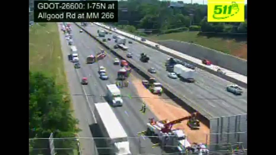 Lanes are closed on Interstate 75 north while crews deal with an overturned dump truck in Cobb County.
