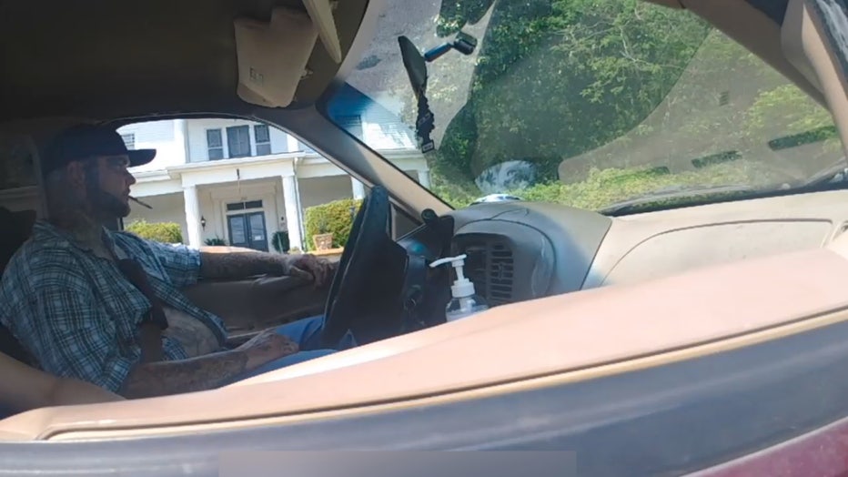 Senoia Police body cam video of Justin Rivers behind the wheel of a pickup truck seconds before he drove off from officers on May 2, 2022.