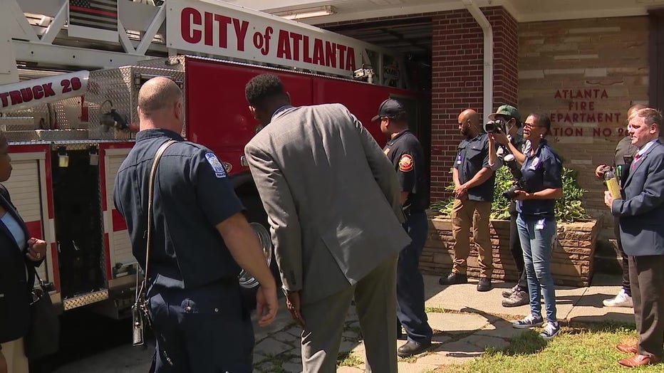 Atlanta Mayor Andre Dickens watches as a ladder truck tries to park inside of an old fire station in Buckhead on May 16, 2022.