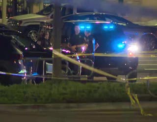 Investigators comb over the parking lot of the Holly Springs Walmart for evidence after a deadly agent-involved shooting on June 13, 2022.